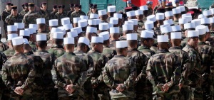 NATO French Foreign Legion soldiers march to a troops review ceremony to celebrate the end of World War One at the Tora forward operating base near Surobi some 50 kilometers (30 miles) east of Kabul, Afghanistan, Wednesday, Nov.11,  2009. (AP Photo/Jerome Delay)